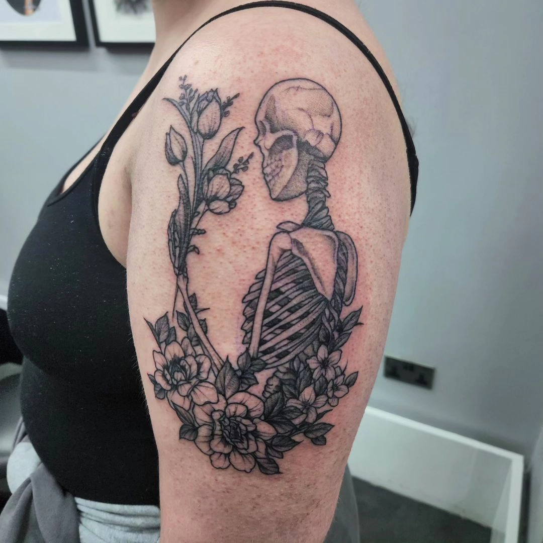 floral skeleton self reflection tattoo