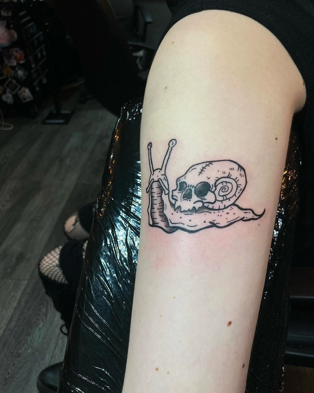 skull and snail symbol tattoo